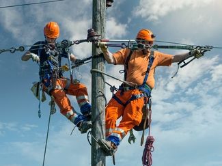 Power line fitters at work